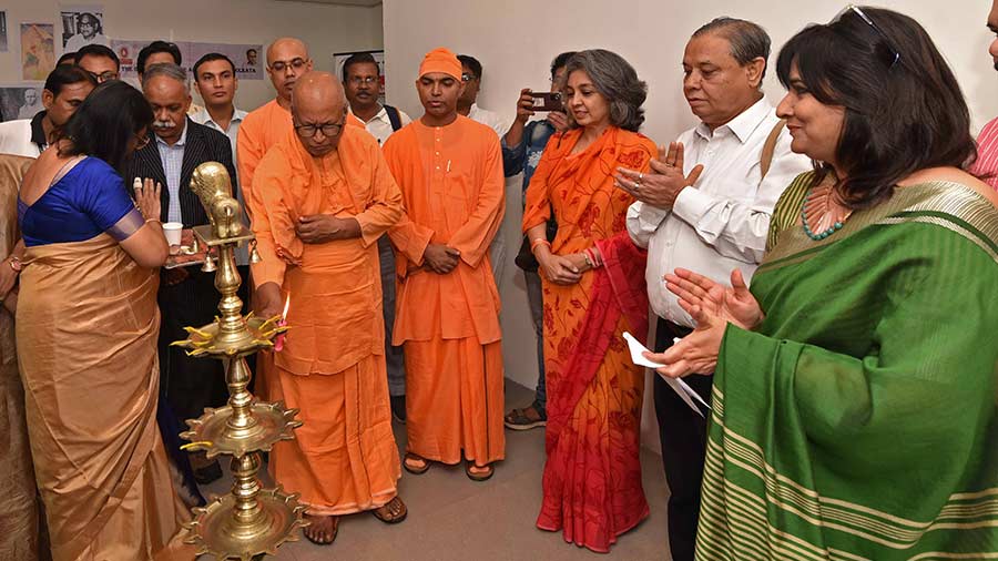Swami Suparnananda lights the lamp at the inauguration ceremony