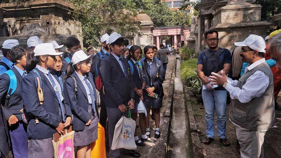 Archaeological engineer Tapan Bhattacharjee explains the methods of cleaning and preservation to the students 