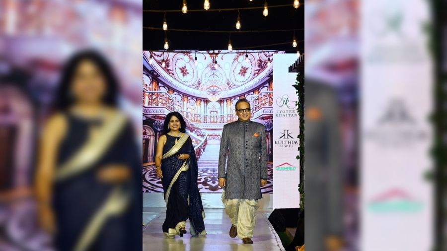 Shukla and Arindam Sil twinned in blue. Arindam in a blue embroidered Indo western paired with stitched dhoti. Shukla in gold sequinned border sari paired with halter neck sequinned blouse