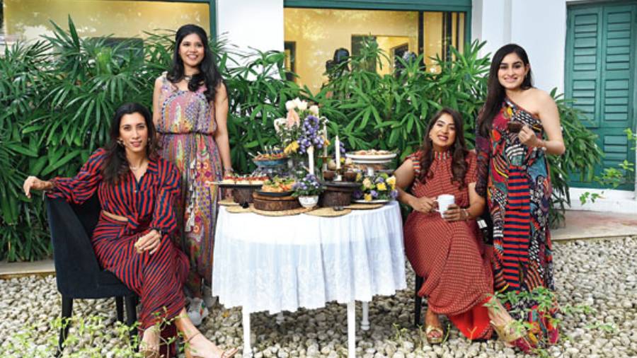 (L-R) Sanaya Mehta Vyas, Shruti Swaika, Malvika Periwal and Vasundhara Mantri at 85 Lansdowne sport effortless work styles set in the backdrop of a high-tea set-up. The special shoot was styled by Shalini Nopany, director, 85 Lansdowne, and curated by 85 Lansdowne. Sanaya looked oh-so-smart in her striped Saaksha & Kinni separates styled with Outhouse earrings. “This outfit took the shape so nicely and when I pulled the zip up, it just felt so snug. It was so well cut,” she smiled. Shruti was in an easy-breezy jumpsuit from Payal Singhal, accessorised with Pehr earrings and necklace, Saree Sneakers’ shoes and a potli from Kaeros. “Wearing the dhoti-style jumpsuit was a lot of fun. I don’t normally wear jumpsuits because I feel they don’t really flatter me, but this was just so comfortable. Even the sneakers are so bright and colourful, and mostly, comfortable. The entire outfit has a quirky element and just perfect for day events,” she said. Malvika was in a colourful dress from SVA teamed with earrings and bracelet from Outhouse. “I loved the vibrant colour of my first outfit, it made me look elegant. It was easy to accessorise too. You can wear it with a pair of earrings and tie your hair back,” she said. Vasundhara was cool and relaxed in Saaksha & Kinni, styled simply with earrings and bracelet from Outhouse. “When I saw the outfit, I felt this is me, vibrant, youthful and comfortable. It was flowy and easy to move around in,” she smiled.  