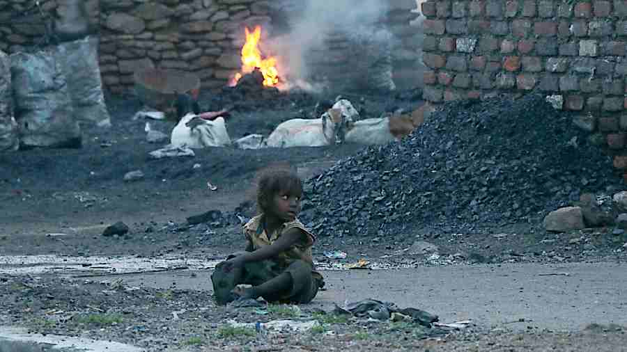 A child plays near burning coal at Jharia in Dhanbad.  