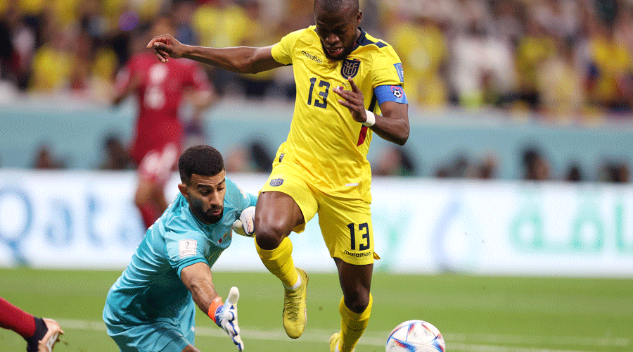 Ecuador’s Enner Valencia (in yellow) is being tripped by Qatar goalkeeper Saad Al-Sheeb during Sunday’s World Cup opener at the Al Bayt Stadium in Al Khor. Valencia was awarded a penalty, which he scored to give Ecudaor their first goal.