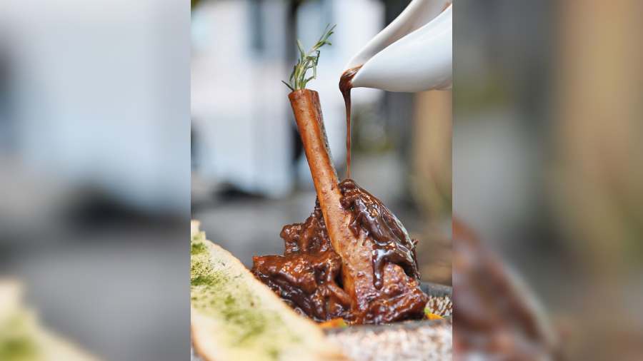 New Zealand Lamb Shank: New Zealand Lamb Shank is cooked and served with rosemary jus and garlic crostini with a side of mashed potato that melts in your mouth