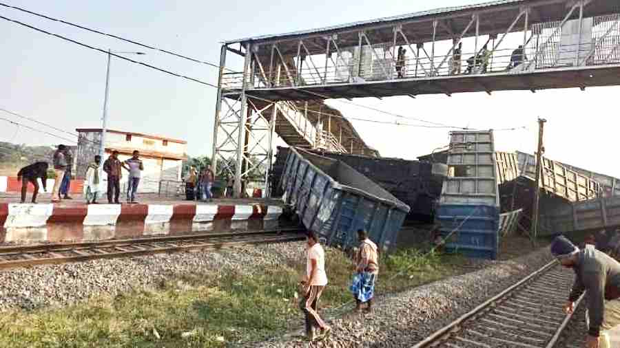 Wagons of the goods train lie on top of each other at Korei station in Odisha’s Jajpur district on Monday.