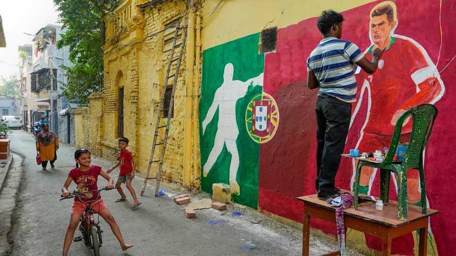 A fan creates a mural featuring football star Cristiano Ronaldo. 