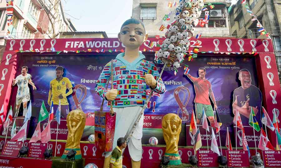 Decorations featuring larger-than-life cutouts of footballers and the trophy mark the ongoing FIFA World Cup 2022 at a residential area in north Kolkata on Tuesday