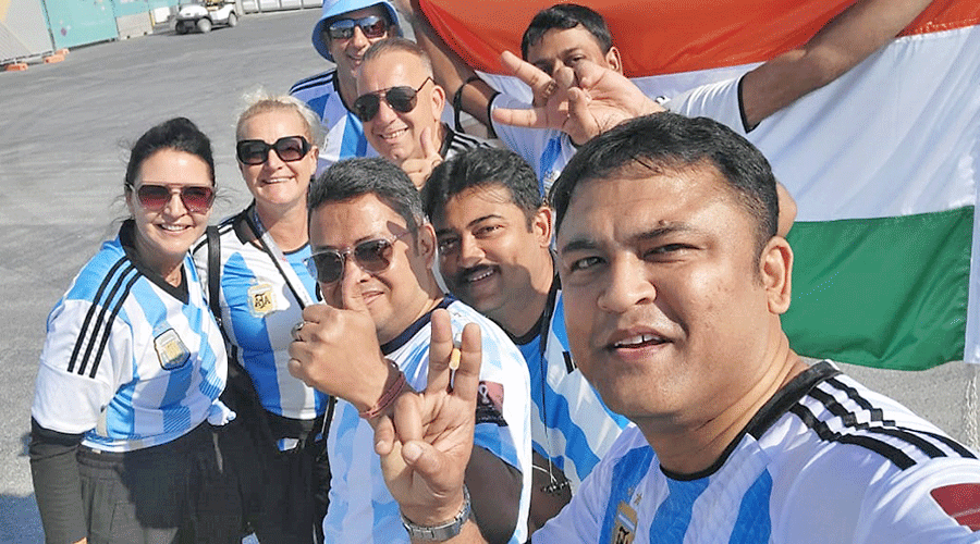 Souvik Biswas (right) with friends outside Lusail Iconic Stadium on Tuesday.