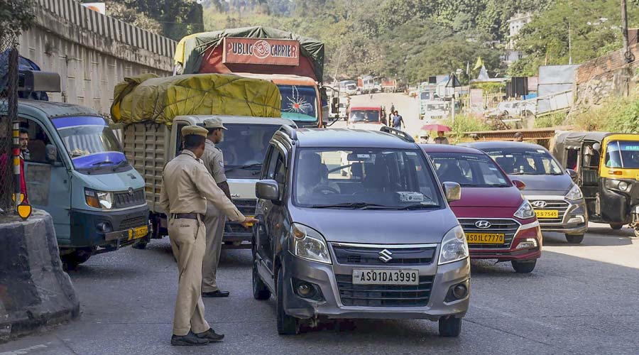 Assam Police personnel stop Meghalaya-bound vehicles for safety reasons, a day after violence at a disputed Assam-Meghalaya border location that killed six people, in Jorabat.
