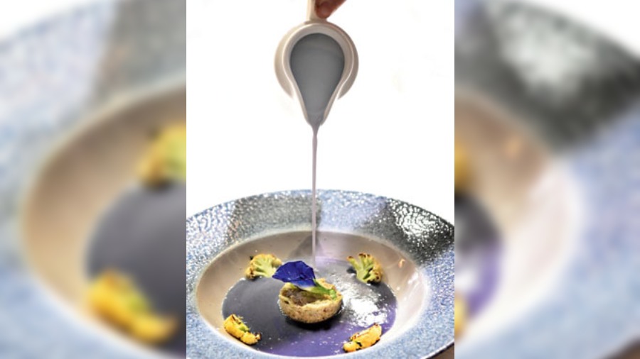 Purple Cauliflower and Butterfly Pea Flower Soup with truffle: A looker of a soup, this one has a beautiful powder-blueish tinge from the pea flower. The addition of truffle brings out the nuttiness of the veggies and elevates the flavours.