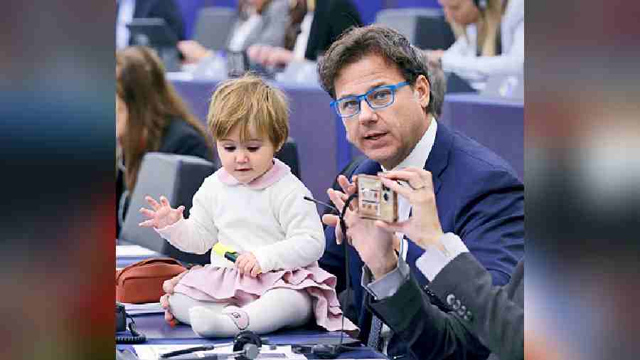Italian member Angelo Ciocca at a ceremony to mark the 70th anniversary of the European Parliament with a child on his desk in Strasbourg, France, on Tuesday. 