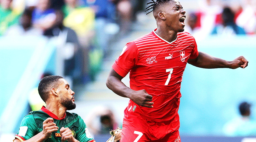 Breel Embolo (in red) is tackled by Cameroon’s Jean-Charles Castelletto during Thursday’s Group G match at Al Janoub Stadium in Al Wakrah. Embolo, who was born in Cameroon, scored the winner for the Swiss.