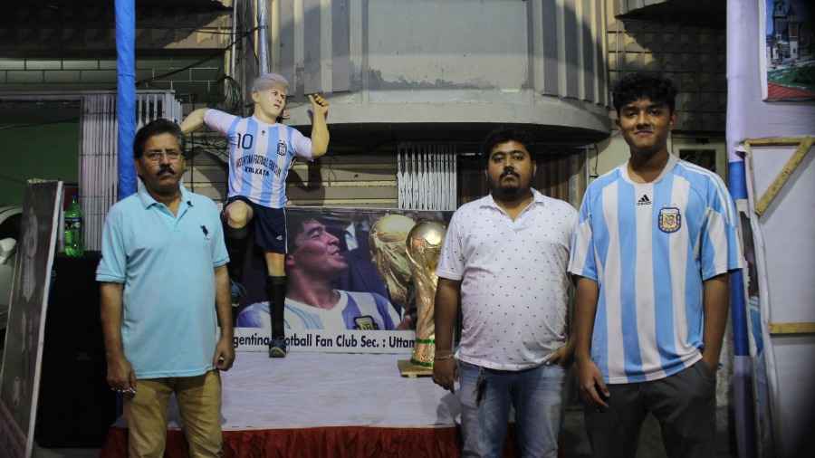 Uttam Saha (left) with his nephew Happy Saha and son Prangan Saha in front of Ganguly Bagan’s Argentina Football Fan Club