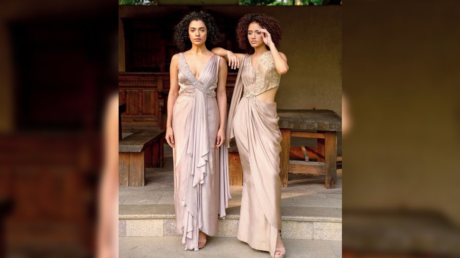 Incorporating shades of moonstone, these two dresses in oyster tones is all about the drape drama. Placement embroidery detailing on the outfits embody the glam quotient of gemstones