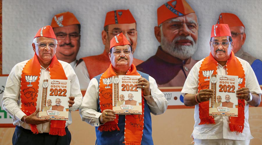 From left- Gujarat Chief Minister Bhupendra Patel, BJP National President J.P. Nadda and State party chief C.R. Patil during release of the party manifesto for Gujarat Assembly elections, in Gandhinagar on Saturday.