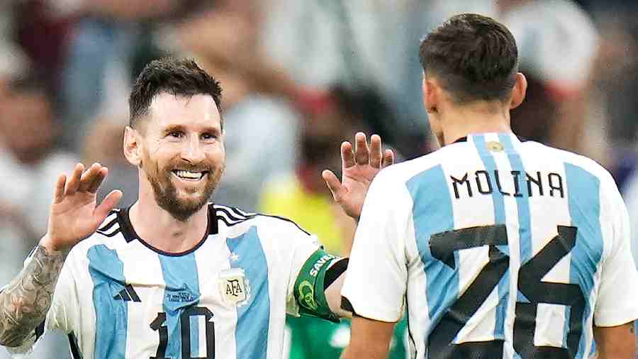 Lionel Messi celebrates with Nahuel Molina after the victory against Mexico at the Lusail Stadium in Qatar. 