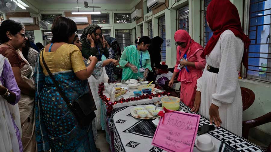  Visitors at the event take a look (and taste) at food prepared by the students