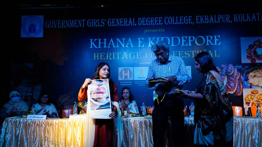 A student showcasing her winning food photograph at Khana-e-Kidderpore heritage food festival