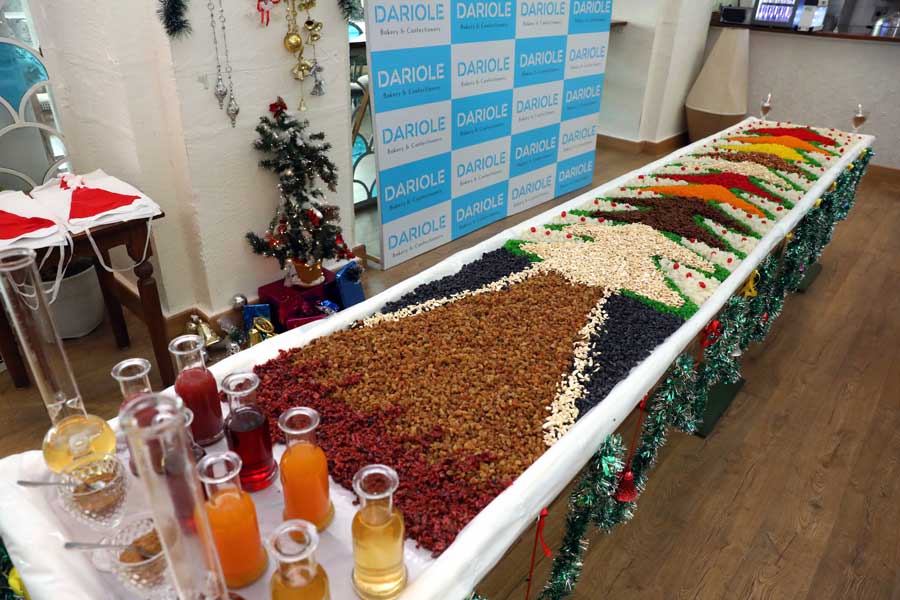 Dry fruits, like almonds, cashew nuts, walnuts and black raisins were laid out in a decorative pattern and soaked in spirits. The mix will be added to the festive bakes