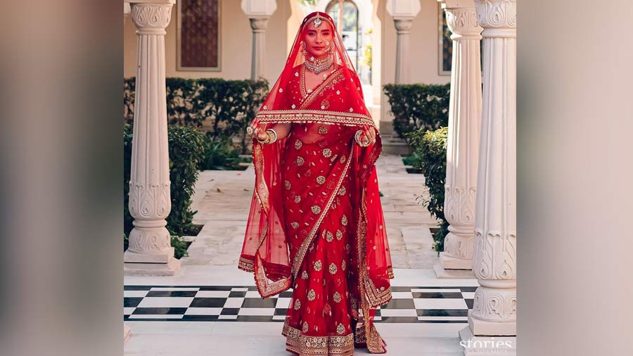 Red hot tulle: Patralekhaa’s red tulle sari is a fashion investment. While red never goes out of vogue, the ‘buti’ work on the sari and customised inscriptions on the veil made the ensemble even more stunning.