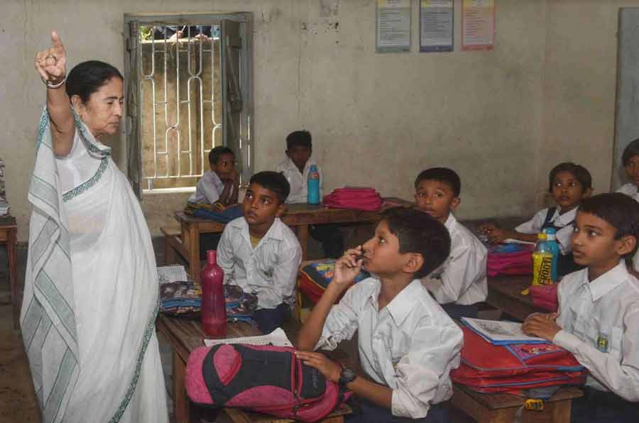 Chief minister Mamata Banerjee interacts with school children during her visit to Hingalganj on Wednesday