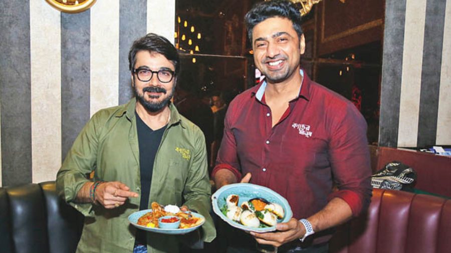 Actors Prosenjit and Dev with Lord of the Drinks puja specials, Chettinad Chicken quesadilla and Kerala Mutton Ghee Roast Bao.