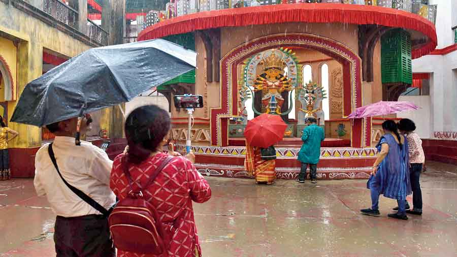 Visitors caught in rain at Ajeya Sanghati Club in Haridevpur on Friday afternoon.  