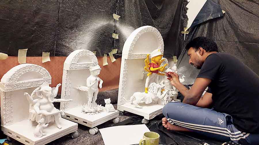 Dipankar Sarkar paints idols for the puja in Germany’s Erlangen.