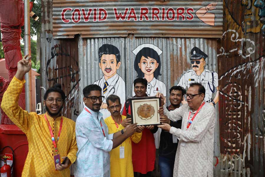 Organisers of the Suruchi Sangha puja with the Nirmal Puja plaque