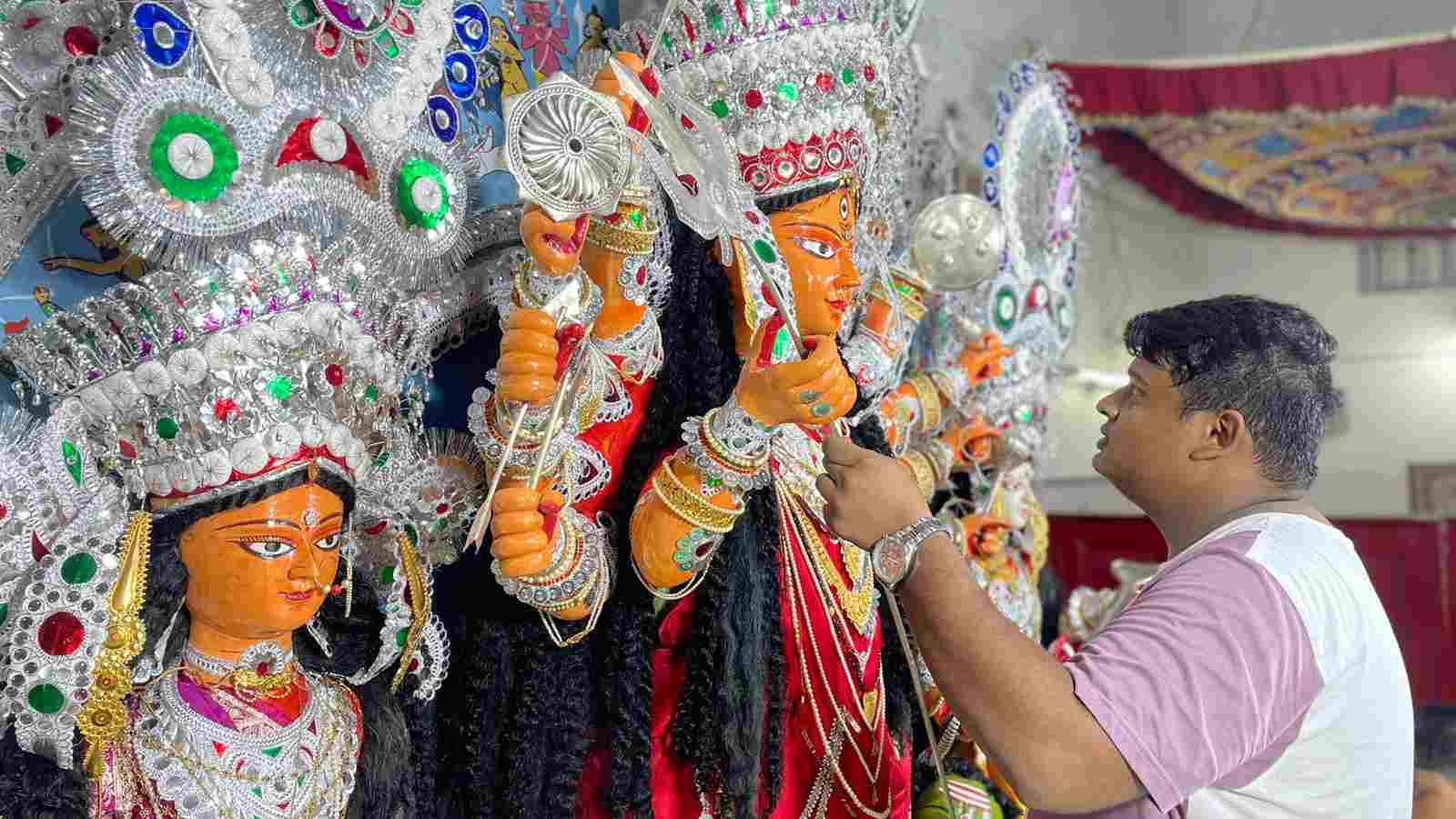 The author helps in decorating Maa Durga with her weapons