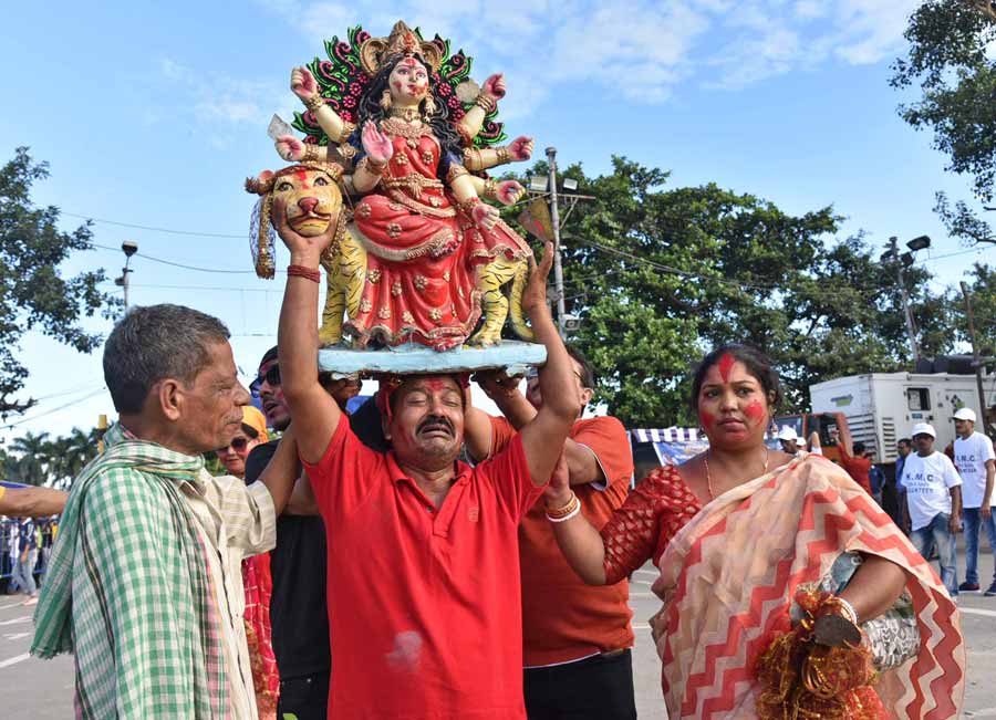 Amid the bigger processions, we also spotted a teary-eyed devotee carrying a small Durga idol on his head, for immersion at Babughat