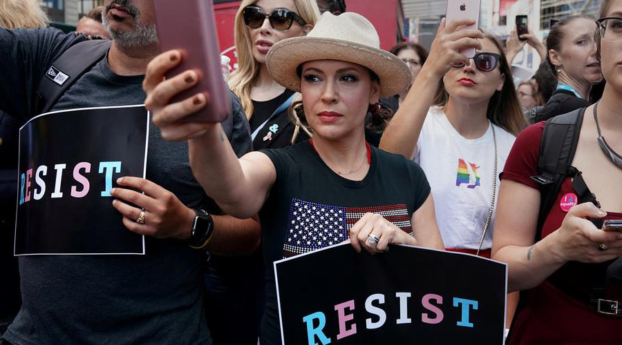 Alyssa Milano (center) also protested Brett Kavanaugh's appointment to the Supreme Court
