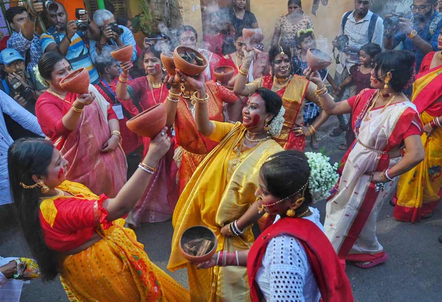Women participate in ‘dhunuchi naach’ as north Kolkata’s Tal Betal Club take their Durga idol for immersion