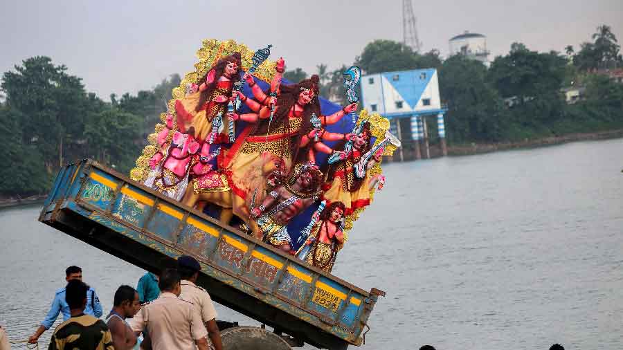 Devi Durga being immersed in the Atrai river at Balurghat in West Bengal