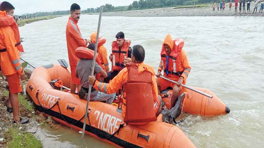 Members of a rescue team on the Mal river at Malbazar on Thursday. 