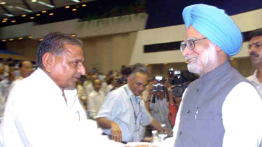 On June 27, 2005, the then Prime Minister Manmohan Singh exchanges greetings with then Uttar Pradesh Chief Minister Yadav at the 51st national development council meeting in New Delhi. 