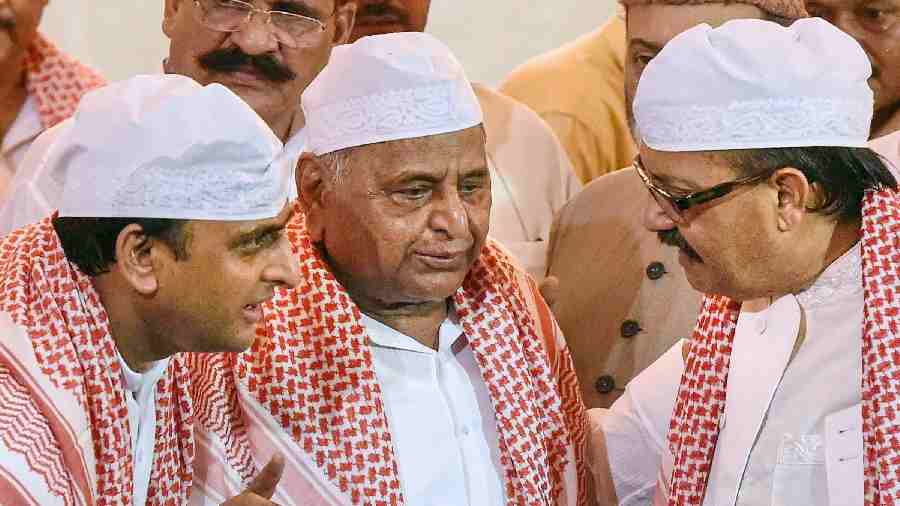 The then Uttar Pradesh Chief Minister Akhilesh Yadav, SP chief Mulayam Singh and leader Amar Singh(R) at a Roza Iftaar party in Lucknow on July 14, 2015. 