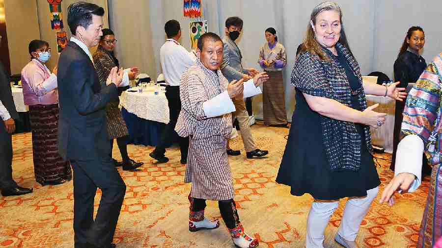The host Chencho Tshering joins guests, including US consul general Melinda Pavek and Chinese consul general Zha Liyou, in tashi labey, a traditional dance to conclude the event