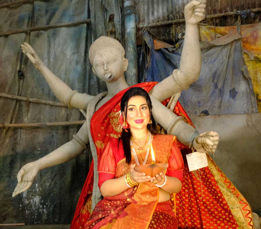 Bangladeshi actor Apu Biswas poses in front of an unfinished idol of goddess Kali in artist Sanatan Rudra Pal’s studio