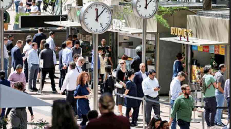 People queue for food in the financial district of Canary Wharf in London.