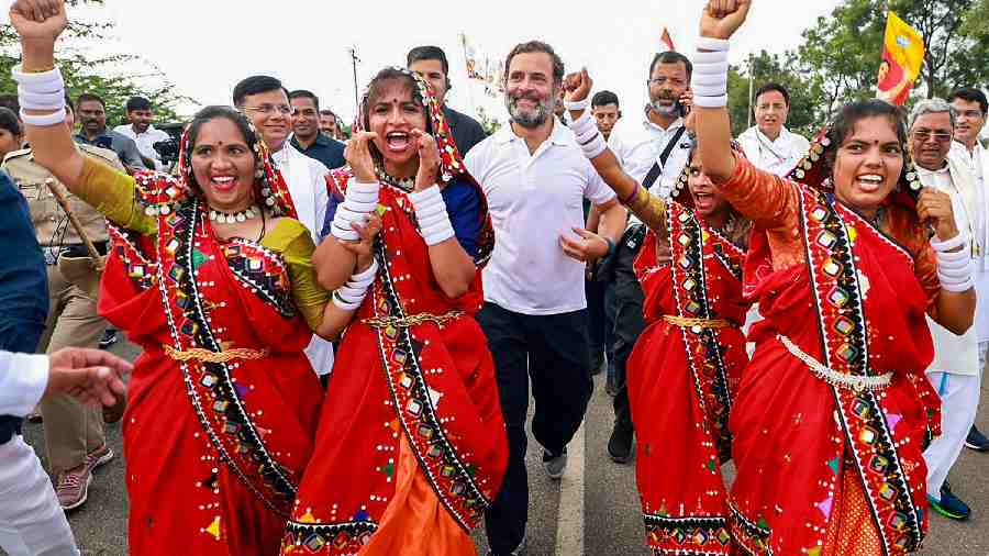 Gandhi runs alongside dancers