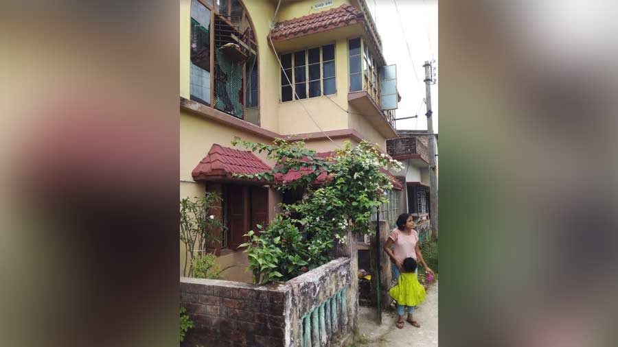 Jayati Chakraborty with her four-and-a-half year-old daughter Mistu in front of the home