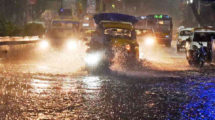 Vehicles amid rain on Chittaranjan Avenue on Wednesday evening. 