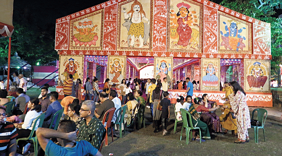 Visitors chat in front of the HB Block pandal.