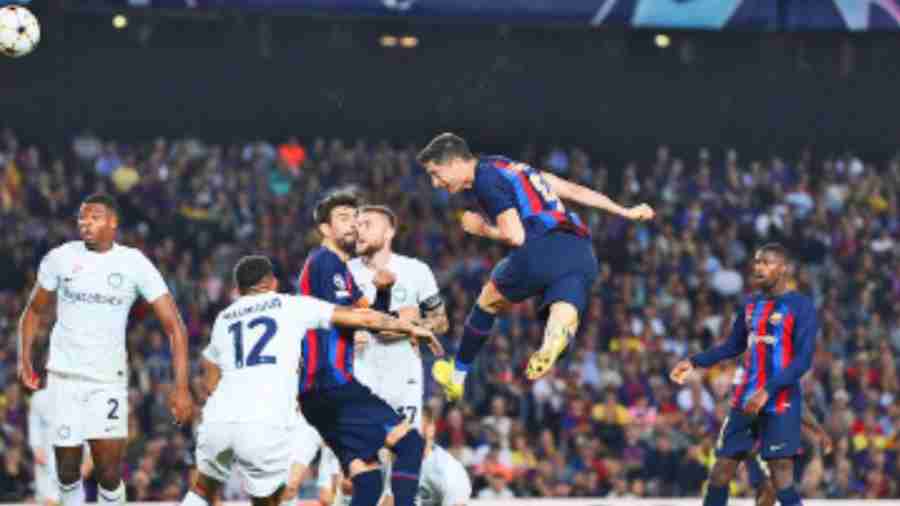 Robert Lewandowski leaps to score Barcelona’s third goal against Inter Milan during the Champions League match at Camp Nou on Wednesday.