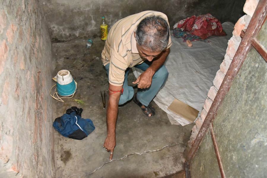 A resident points to the crack on the floor. At least 10 houses developed cracks on Friday morning in the Bowbazar area of Kolkata, following water seepage during work in the East-West Metro tunnel there