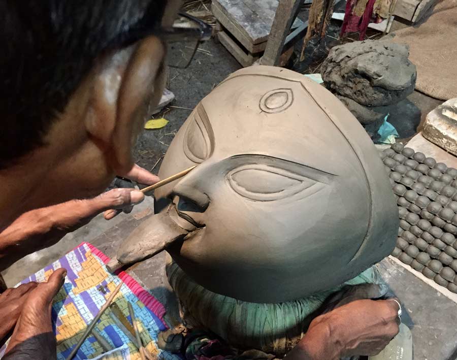 Artist Pashupati Rudra Paul creates his magic on a clay idol of Goddess Kali at Kumartuli on Friday