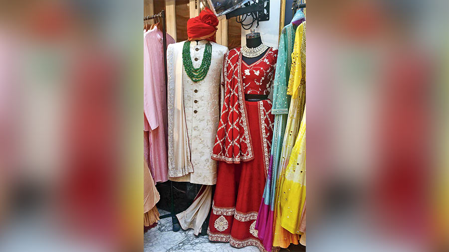 Hand- embroidered in  raw silk with intricate zardozi work all over, this sherwani jacket is just perfect for the bridegroom. The sindoor-red raw silk lehnga  with hand- zardozi  embroidery is suitable for the bridesmaid or the sister or mother of the bride or groom. Both from Allure. Price on request.