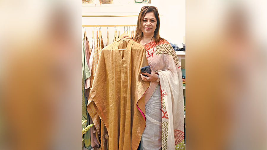 Apala Datta, principal, Birla Bharati School, picks up a tissue kaftan for Diwali
