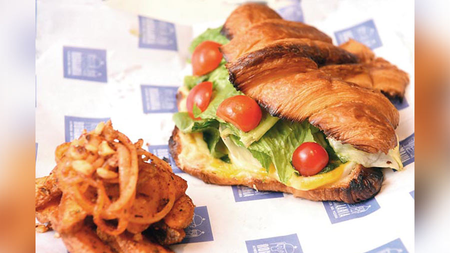 Croissant Sandwich is a must-try with your coffee. Freshly baked, crispy and flaky croissants are stuffed with cheese, cherry tomatoes and lettuce. Yum!