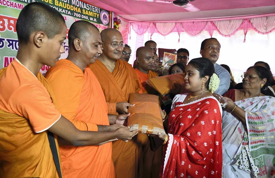 Devotees donate clothes to Buddhist monks at the Tollygunge Sambodhi Buddhist Temple on Saturday as part of the robe-offering ceremony